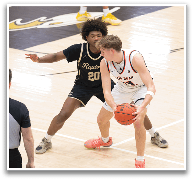 Two basketball players on a court, one with a red jersey and the other with a black jersey. The red jersey player is holding a basketball. AI generated content