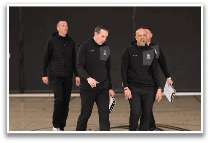 Three men wearing black clothing are standing on a basketball court. AI generated content