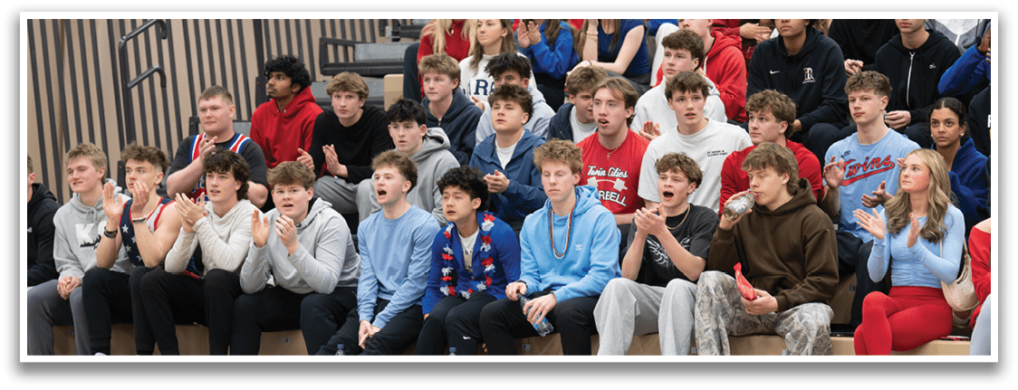 A group of people are sitting on a bench in a stadium, watching a game. AI generated content