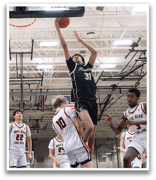 A basketball player leaps in the air to block a shot, while other players look on. AI generated content