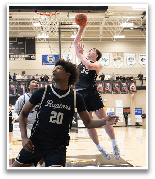 Two basketball players are playing in a game. One player is jumping up to block a shot, while the other player is running towards the basket. AI generated content