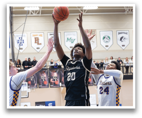 Basketball players in action on a court. One player is jumping to block a shot, while another player is reaching for the ball. AI generated content