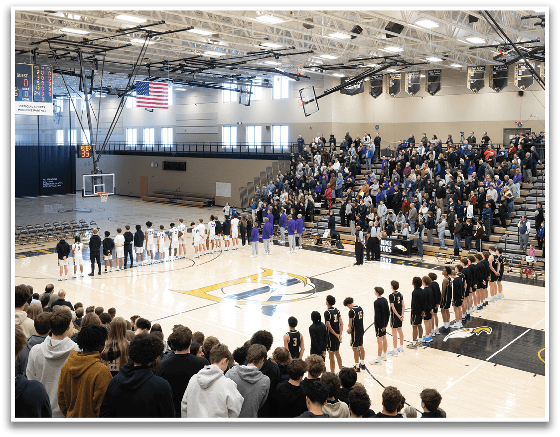A group of people are standing on a basketball court, with some of them wearing uniforms. The crowd is watching the game, and there are chairs placed around the court. AI generated content