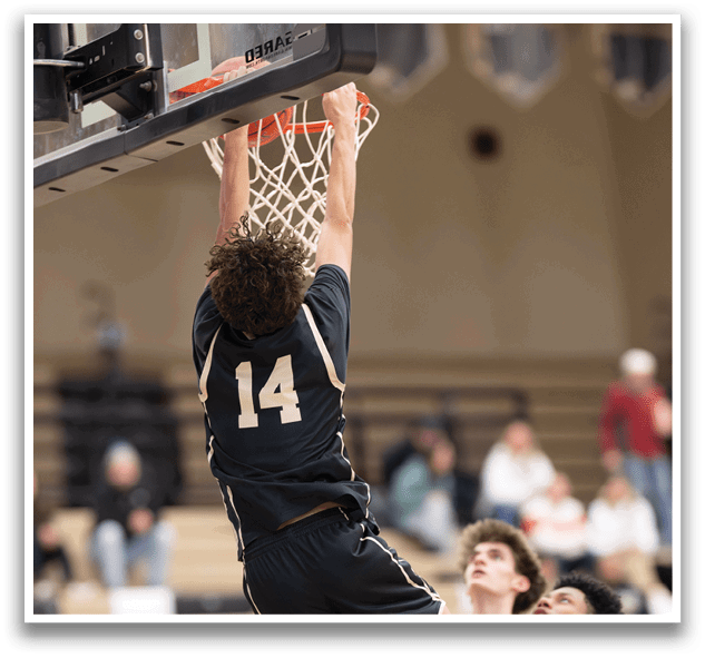 A basketball player is jumping to dunk the ball through the hoop. AI generated content