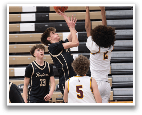 A basketball game is in progress with a player in a black jersey attempting to block a shot. AI generated content