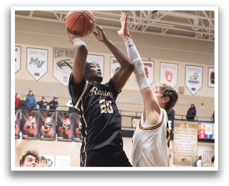Two basketball players are fighting for a rebound, with one player jumping in the air to grab the ball. AI generated content