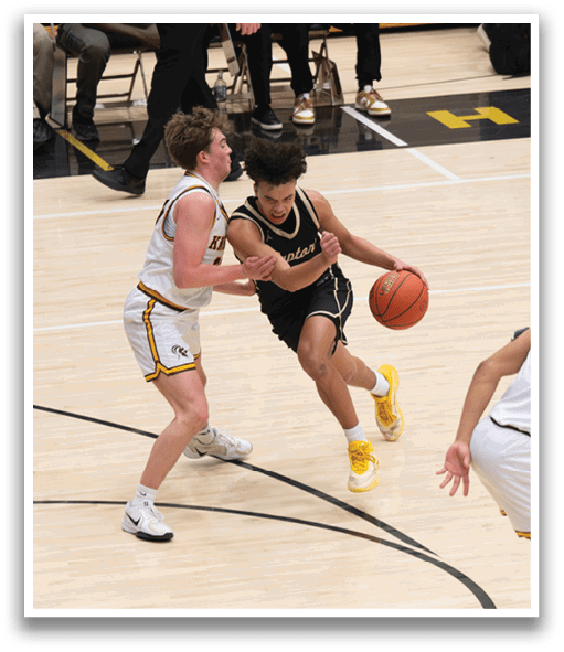 A basketball game is in progress with players on the court. One player is holding a basketball while another player tries to take it from him. The players are wearing uniforms and are actively engaged in the game. AI generated content