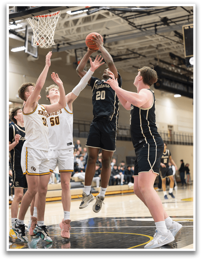 A basketball game is in progress with a player jumping to block a shot. AI generated content