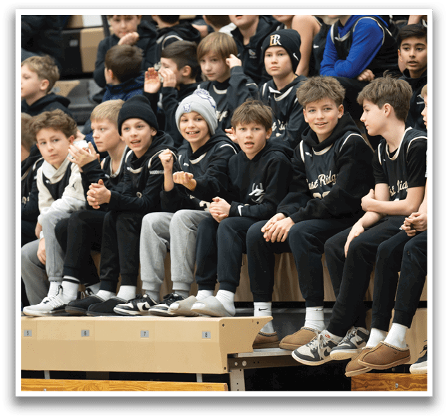 A group of young boys are sitting on a bench, watching a game. AI generated content