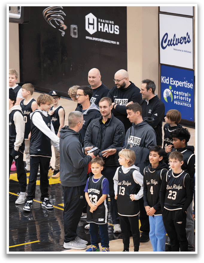 A group of young basketball players are lined up on the court, wearing their uniforms. AI generated content