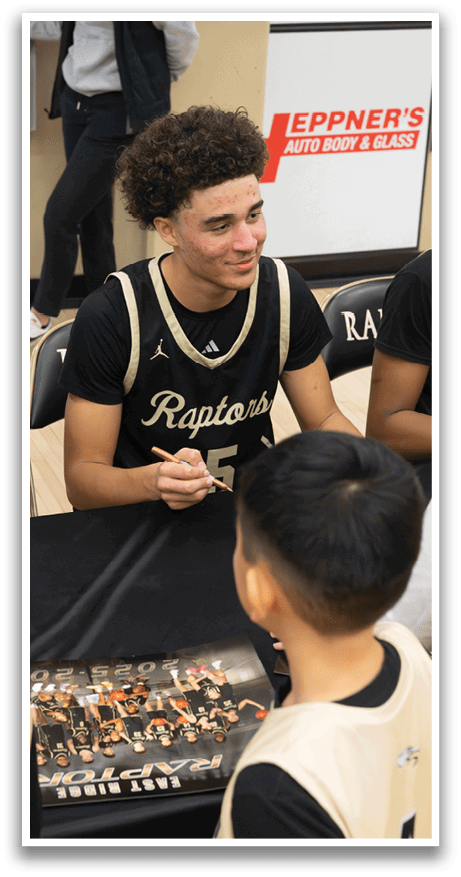 A group of young men and boys are gathered around a table, signing autographs for the children. AI generated content