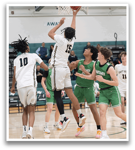 Basketball players on a court, one of them jumping to block a shot. AI generated content