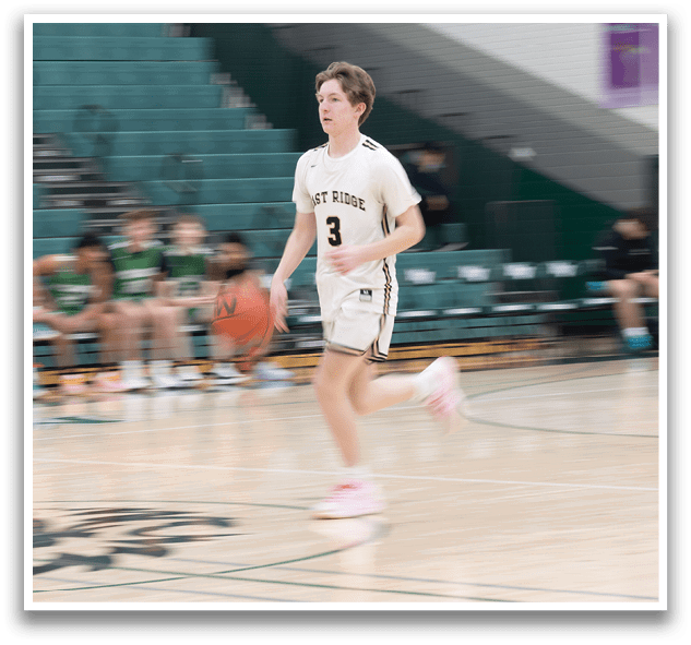 A boy in a white shirt and black shorts is running on a basketball court. AI generated content
