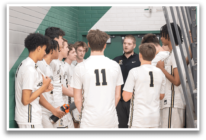 A group of young men wearing white jerseys are standing in a hallway, listening to a coach. AI generated content