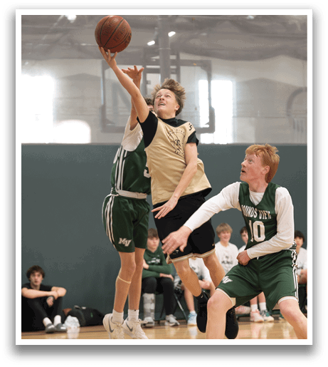 Two boys are playing basketball, one of them jumping in the air to shoot the ball. AI generated content