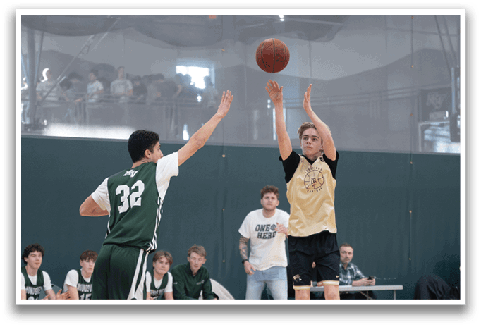 Two men playing basketball, one with the ball and the other trying to block him. AI generated content