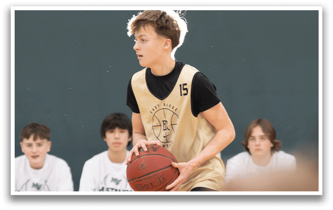 A young boy wearing a basketball uniform is holding a basketball. AI generated content