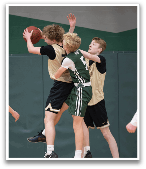 Three boys playing basketball, one of them jumping to grab the ball. AI generated content