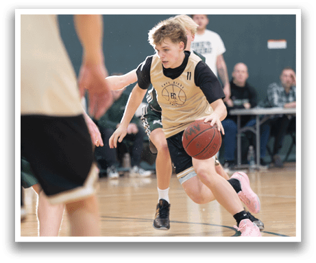 A boy in a basketball game is running with a basketball in his hand. AI generated content