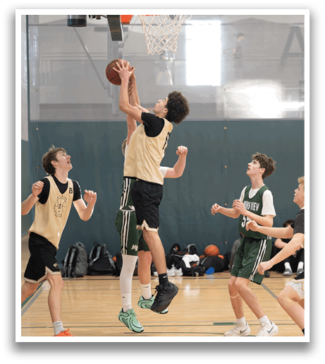 A group of young men playing basketball, with one man jumping to block a shot. AI generated content