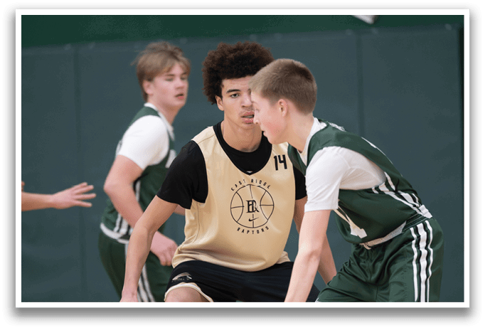 Two basketball players are on the court, one with a ball in his hand, while the other player is trying to block him. AI generated content