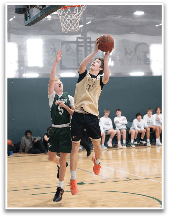 Two men are playing basketball, one of them jumping to shoot the ball. AI generated content