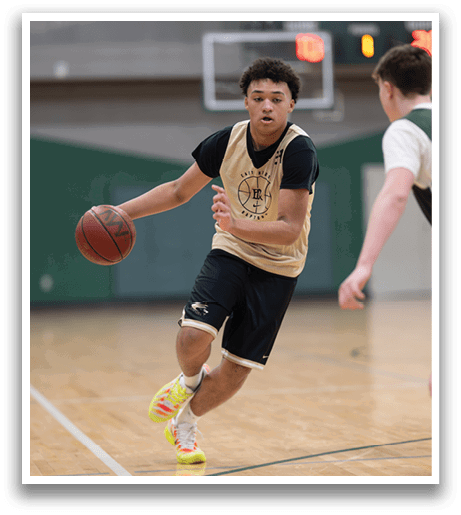 A basketball player wearing a gold and black jersey is running with the ball. AI generated content