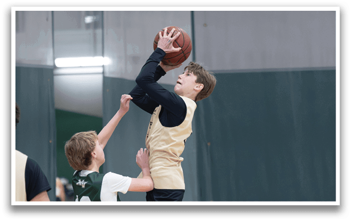 Two boys playing basketball, one jumping to block the other's shot. AI generated content