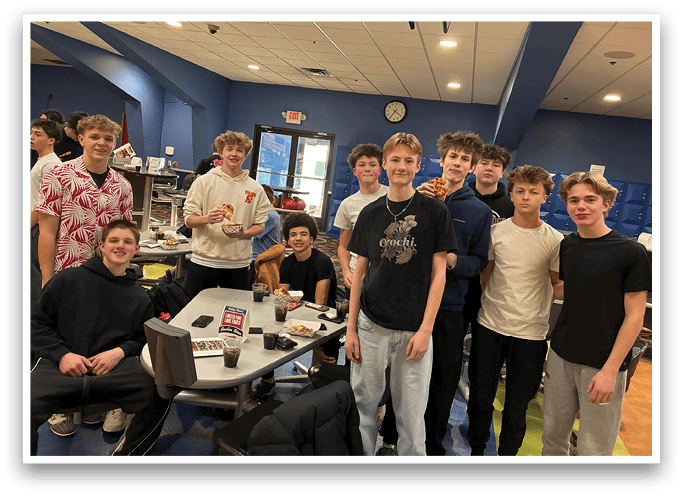 A group of young people are standing around a table with pizza and drinks. AI generated content