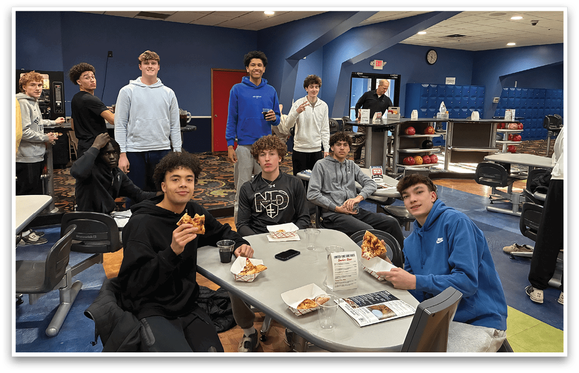 A group of young people are sitting around a table eating pizza. AI generated content
