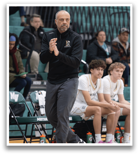 A man in a black jacket is clapping while standing on a basketball court. AI generated content