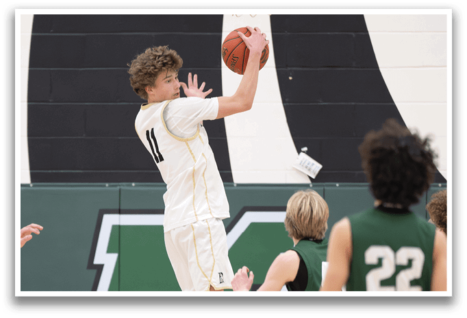 A basketball player jumps to block a shot, while other players look on. AI generated content