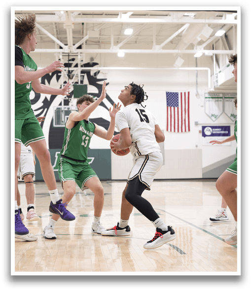 A group of young men playing basketball, with one player attempting to block another player's shot. AI generated content