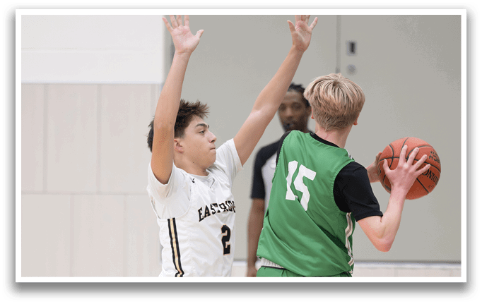 Two basketball players on a court, one with a green jersey and the other with a white jersey. AI generated content