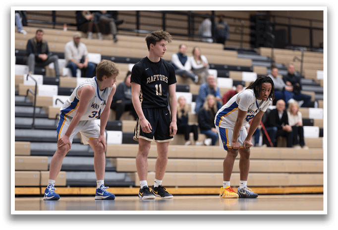 Three basketball players are on the court, one of them wearing a black shirt. They are all looking at the same direction, possibly anticipating the next play. AI generated content