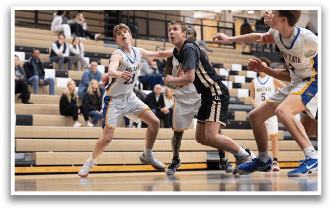 A group of young men playing basketball on a court. AI generated content