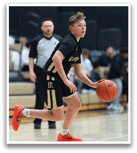 A boy in a basketball uniform is running with a basketball in his hand. AI generated content