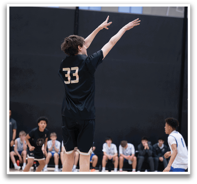 A basketball player wearing a black shirt with the number 33 on it is jumping to catch a basketball. AI generated content