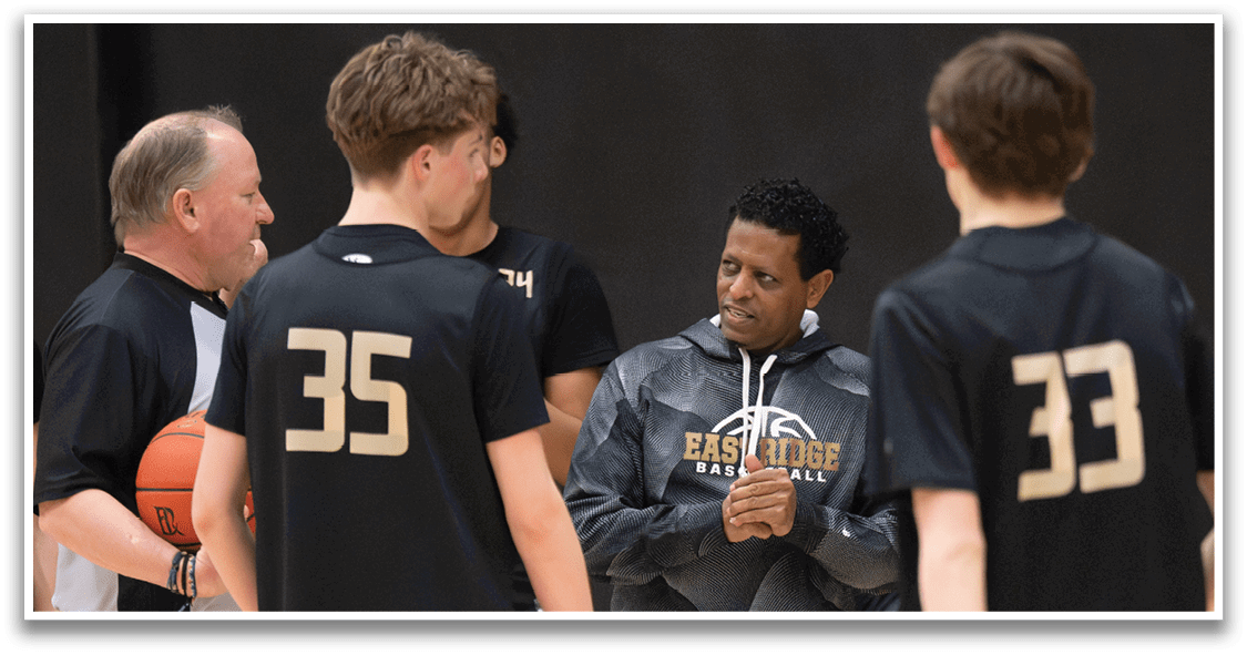 A group of young men are standing on a basketball court, engaged in a conversation. One of the men is holding a basketball. AI generated content
