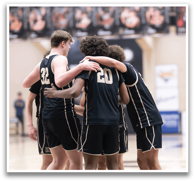 A group of basketball players huddle together on the court, with one player holding his head. AI generated content