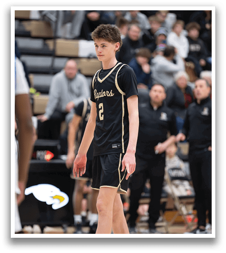 A young man wearing a basketball uniform stands on a basketball court. AI generated content