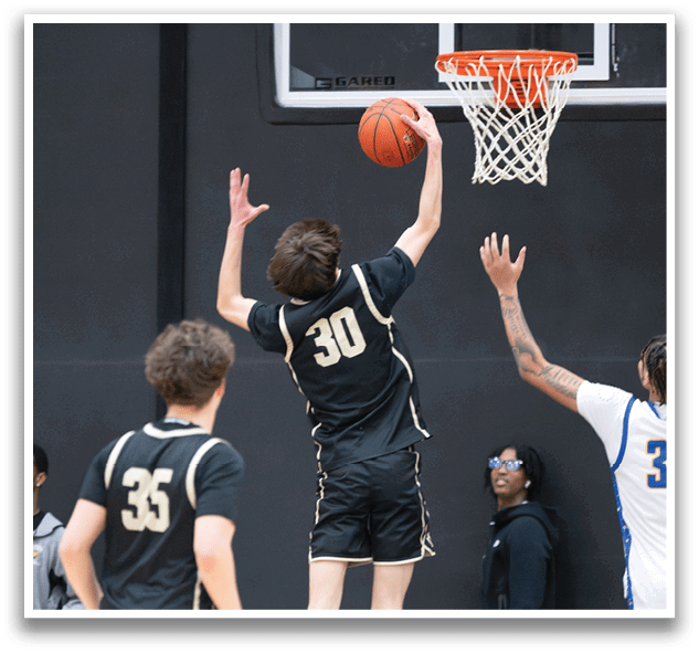 A basketball player jumps to block a shot, while another player looks on. AI generated content