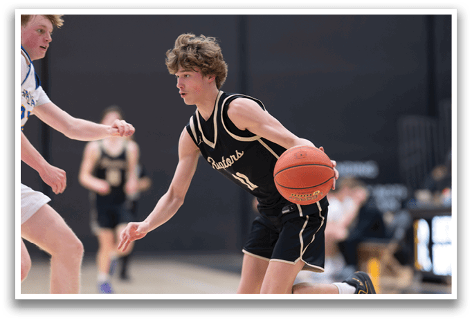 Two basketball players on a court, one holding a ball and the other trying to block him. AI generated content