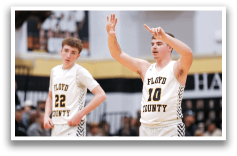 Two men wearing basketball uniforms are on the court, one of them pointing upwards. AI generated content