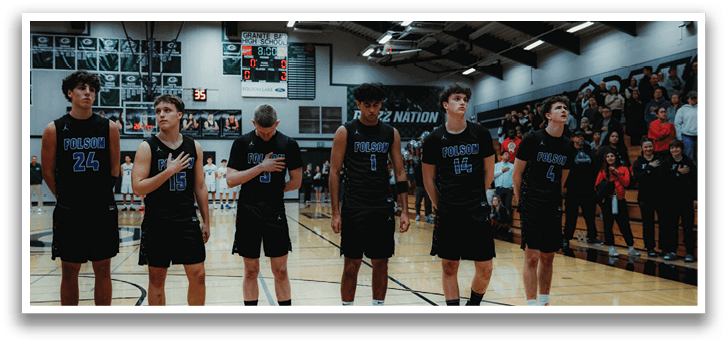 A group of young men wearing black uniforms stand on a basketball court. AI generated content