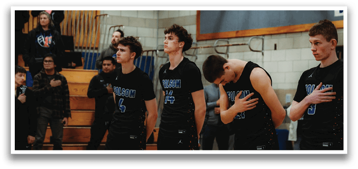 A group of young men wearing black jerseys stand on a basketball court. AI generated content