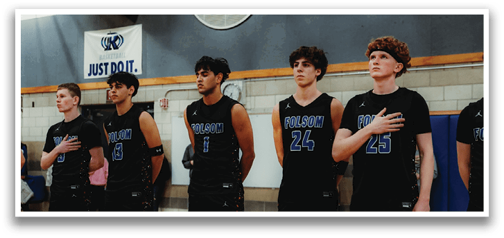 A group of young men wearing black shirts and shorts are standing on a basketball court. AI generated content