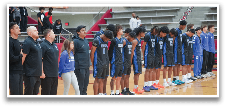 A group of basketball players are lined up on the court, wearing blue and black uniforms. AI generated content