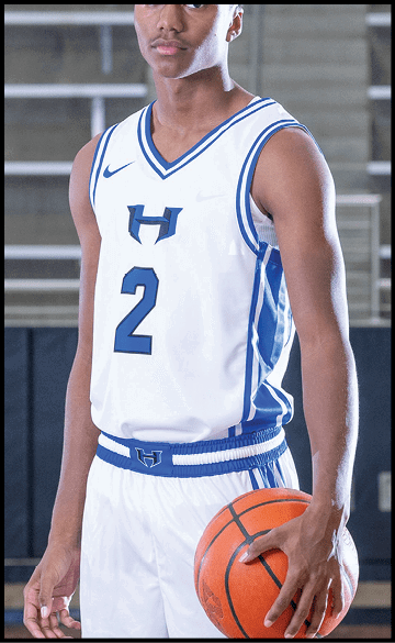 A young man wearing a basketball uniform holds a basketball in his hands. AI generated content