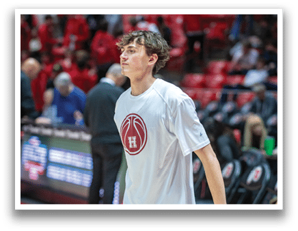 A man wearing a white shirt and red shorts is walking on a basketball court. AI generated content